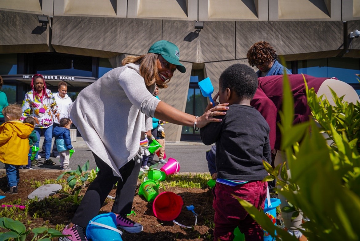 Acting Secretary Adrianne Todman interacting with children during planting event